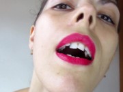 Gentle giantess playfully threatening to eat tiny man