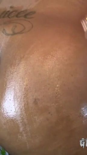 Big booty ebony Jazzy drenches her massive black ass with oil