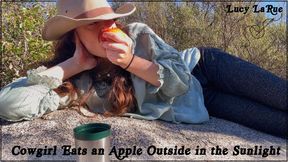 Cowgirl Eats an Apple Outside in the Sunlight