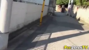 Asian JAV Star Urinates Outdoors in Seductive Car Park Showdown