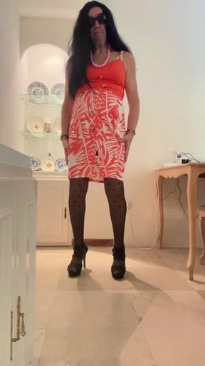 Beautiful and horny Spanish trans girl with long legs cums in an orange dress, skirt and top, black heels, and lingerie