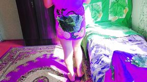 Playful Sissy Sitting Cross-legged on Fluffy Pink Carpet