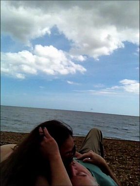 On the Beach riding a sunbather while people watch