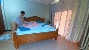 Nudist housekeeper Regina Noir makes the bedding in the bedroom. Naked maid. Naked housewife. 1