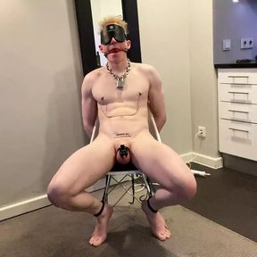 Gay slave in chastity tied up on chair gagged and blindfolded