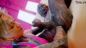Tattooed dominatrix in pink Fishnet