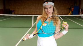 Alice Klay headband on, sneakers up, she spreads on the green court