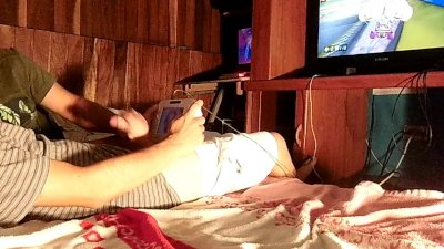 Horny lad is playing some video games while jerking off
