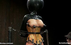 Bound busty slave in latex tormented