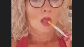 Smoker MILF Joan smokes slowly close up Marlboro red 100 with Glasses, shiny glossy red lips, deep inhalations and long exhales