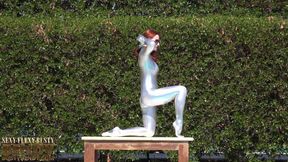 Bending in a Silver Spandex Suit