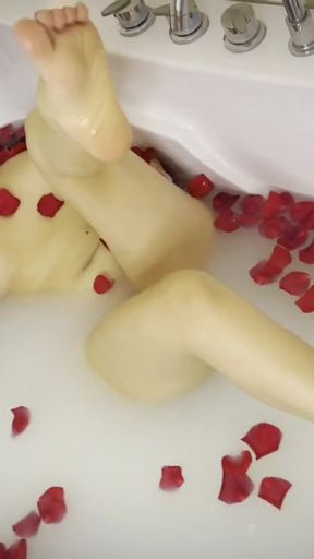 a milk shower with roses, and playing with her feet   Clip 1
