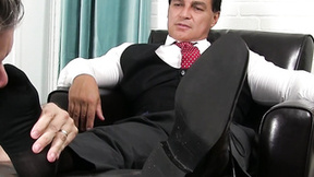 Mature Latino businessman enjoys his foot being licked