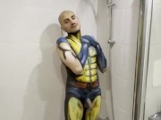 Sexy boy having a hot shower rubbing off body paint