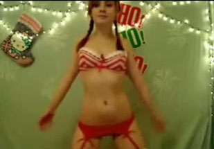 Sweet teen ctltbrating x-mas in front of a web camera