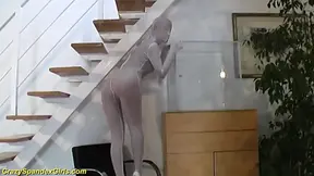 Spandex girl squeezes herself in a glass box