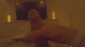 Massage of a large penis in front of a large TV