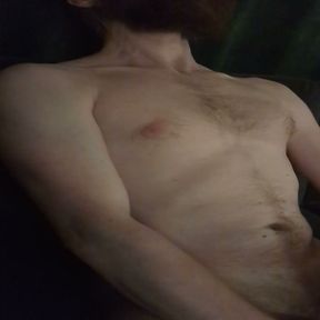 Nude male masturbating on couch