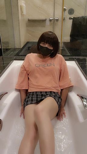 Shemale Ting xuan takes a bath in the bathtub wearing clothes