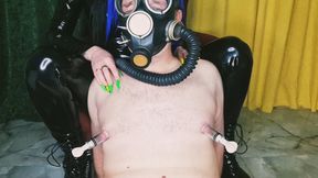 Slave in a gas mask. Fetish. Pumping male nipples, playing with nipples.