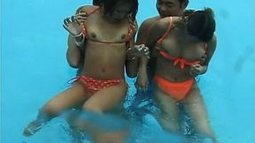 Two frisky Jap girls bathing in a pool having much fun