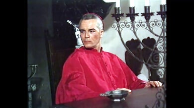 Blonde in vintage Italian gown submits to priest in candlelit stone chamber