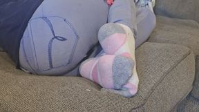 Chrissy laying on couch in puma socks