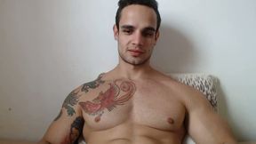 Muscular Tattooed Man Flexes His Muscles and Remains Seated