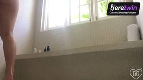 A natural nude lady milks in a shower