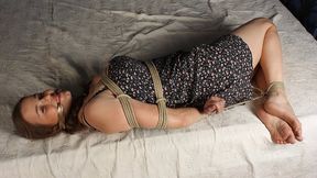 Anne: cleave-gagged barefoot girl in colorful dress, hogtied with hemp rope, rolls and wiggles on the bed (HD MP4)