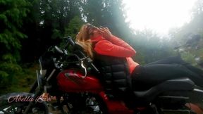 Red lips blonde smoking sensually on Rasta bike outdoor
