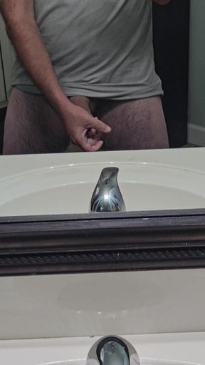 Hot babe strokes her pussy while checking reflection