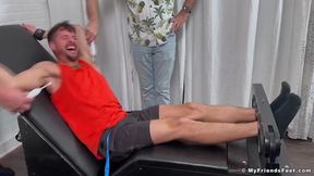 Bound gay jock gags on toes while threesome tickles his feet hard