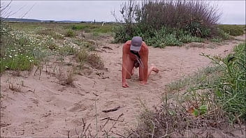 naked pathetic slave in penis cage crawling at the gay beach with dogtail, BDSM CBT