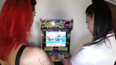Two young women play video games and then have strapon sex