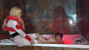 Foot domination by two superheroines in a bath