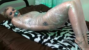 ”Blonde chick Nadia White wrapped up in plastic”
