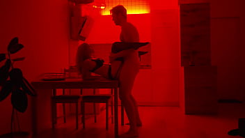Romantic couple sex under red neon