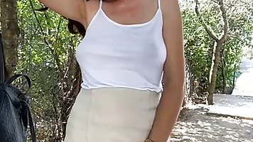 Busty, amateur brunette is fingering her pussy in front of the camera, in the backyard
