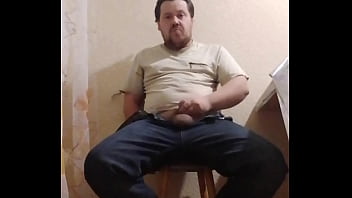 A fat gay man sat down on a chair to masturbate his little cock