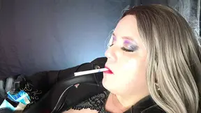 Smoking goddess teases in leather jacket
