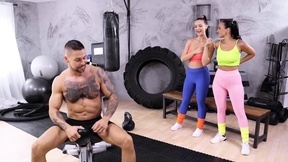 Lady Gang and Claudia Bavel pleasuring tattooed stud in the gym