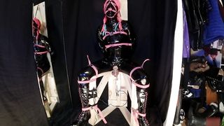 Tied to Pummeling Machine Stool in vinyl Catsuit Ball-Gagged in Virginity