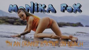 gorgeous monika fox in an orange bikini on beach