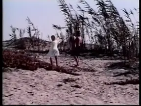 Two hot blondes with great bodies enjoy sensual lesbian sex on the beach.
