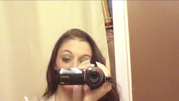 Brunette slut with handicam tapes herself stripping in the can