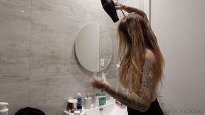 Blow drying, oiling and combing long blonde hair