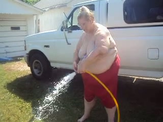 BBW granny with saggy boobs is playing with hose outdoor