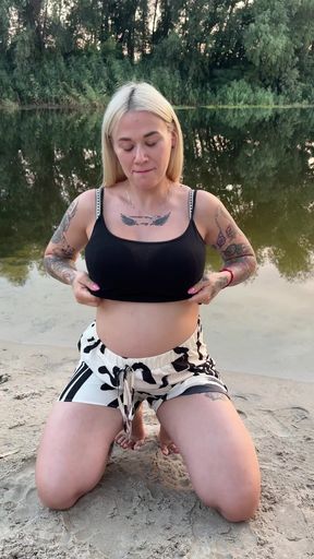 Pregnant woman sitting on beach
