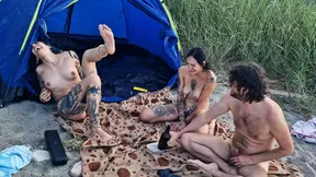 Two stunning girls get naked on the beach for a dirty spin the bottle game